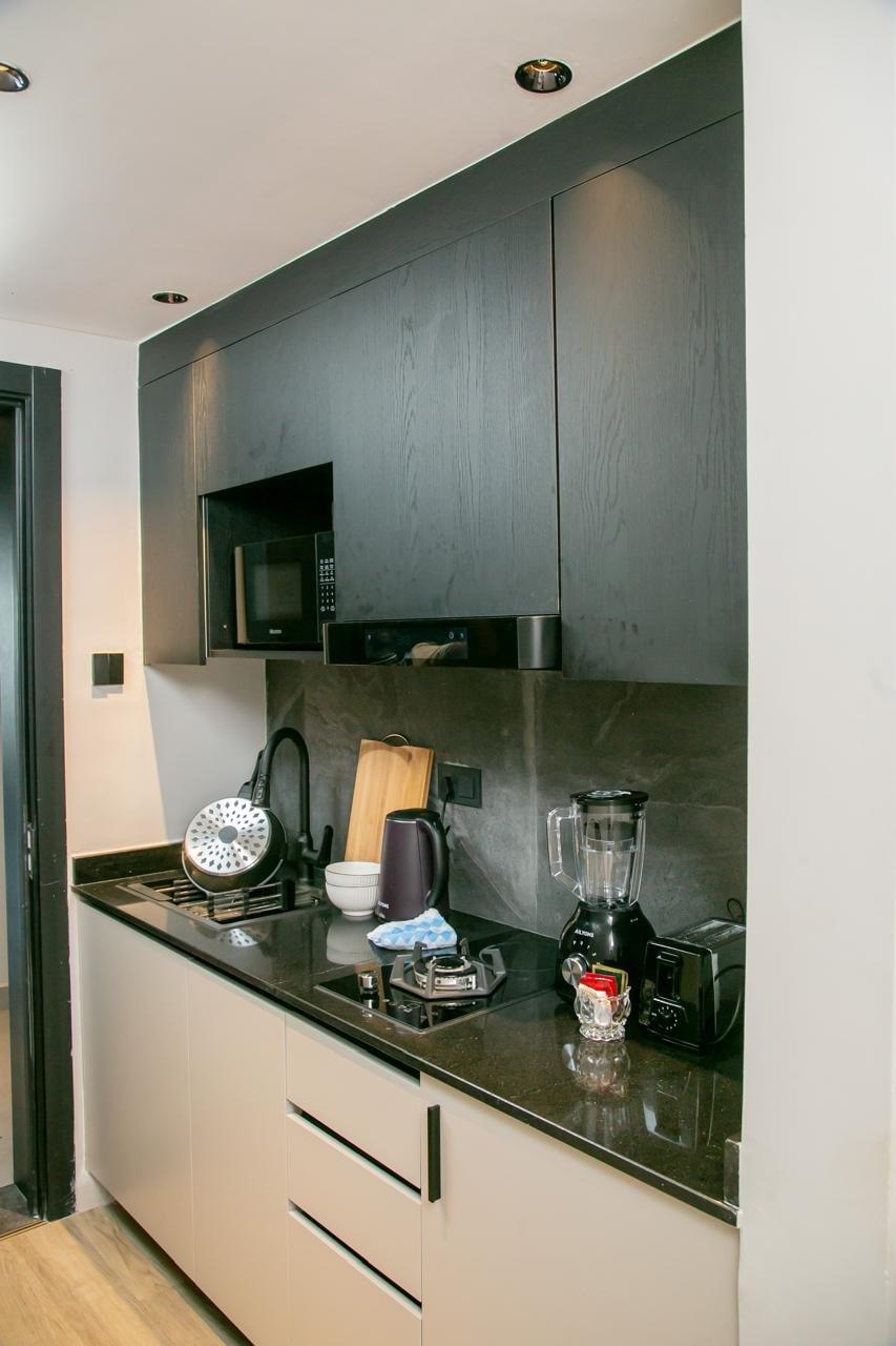 The fitted kitchen, with hob, microwave and full-height cabinets