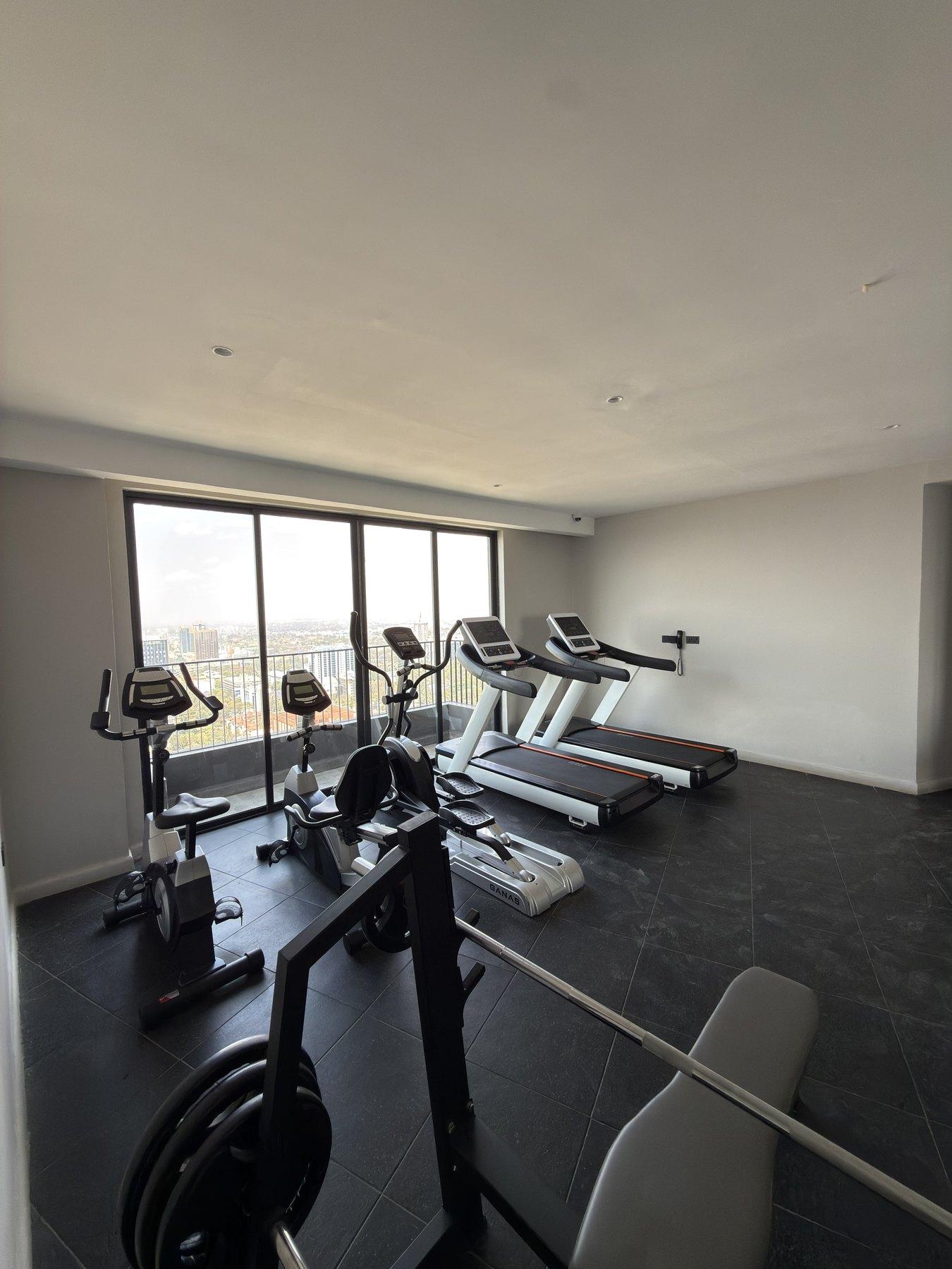 The gym, with treadmills facing the window